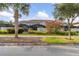Townhouse exterior with landscaping and palm trees at 4825 Clock Tower Dr, Kissimmee, FL 34746