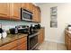 Kitchen with granite countertops and stainless steel appliances at 4825 Clock Tower Dr, Kissimmee, FL 34746