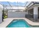 Private screened pool and spa with grill at 4825 Clock Tower Dr, Kissimmee, FL 34746