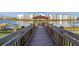 Wooden walkway to a dock with kayaks and lake access at 4825 Clock Tower Dr, Kissimmee, FL 34746