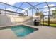 Private screened pool and spa with grill at 4825 Clock Tower Dr, Kissimmee, FL 34746