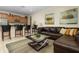 Spacious living room with a leather sectional sofa and a coffee table at 4825 Clock Tower Dr, Kissimmee, FL 34746