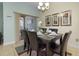 Dining room with a marble top table and six chairs, near sliding doors at 4825 Clock Tower Dr, Kissimmee, FL 34746