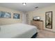 King-size bed, dresser, and full-length mirror in this bedroom at 4825 Clock Tower Dr, Kissimmee, FL 34746