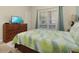 Well-lit bedroom with a dresser, TV and comfortable bed at 4825 Clock Tower Dr, Kissimmee, FL 34746