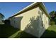 Side view of yellow house with windows and landscaping at 2221 The Oaks Blvd, Kissimmee, FL 34746