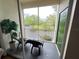 Screened balcony with patio furniture and wooded views at 8826 Dunes Ct # 207, Kissimmee, FL 34747