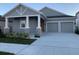 Two-story house with gray siding and stone accents at 15669 Honeybell Dr, Winter Garden, FL 34787