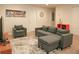 Comfortable living room with gray sectional sofa and arm chair at 2022 Majorca Dr, Kissimmee, FL 34747