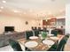 Open concept dining area with glass table, dark chairs, and kitchen view at 2022 Majorca Dr, Kissimmee, FL 34747