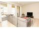 Living room with sectional sofa, sliding glass doors, and access to patio at 2022 Majorca Dr, Kissimmee, FL 34747