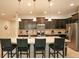 Modern kitchen with dark cabinets, granite island, and stainless steel appliances at 2022 Majorca Dr, Kissimmee, FL 34747
