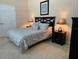 Bright bedroom with a king-size bed and ensuite bathroom at 1387 Lexington Ave, Davenport, FL 33837