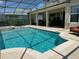 Screened-in pool and spa with ample deck space for lounging at 1387 Lexington Ave, Davenport, FL 33837