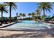 Large resort-style pool with palm trees and lounge chairs at 121 Kenny Blvd, Haines City, FL 33844