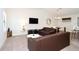 Open living room with brown leather couches and kitchen view at 121 Kenny Blvd, Haines City, FL 33844