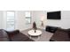 Living room with brown leather couches and patio access at 121 Kenny Blvd, Haines City, FL 33844