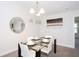 Bright dining room featuring a glass table and four chairs at 121 Kenny Blvd, Haines City, FL 33844