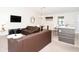 Open living room with brown leather couches and kitchen view at 121 Kenny Blvd, Haines City, FL 33844