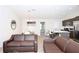 Open living room with brown leather couches and kitchen view at 121 Kenny Blvd, Haines City, FL 33844