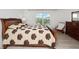 Bright bedroom with a queen bed, dresser, and a large window with natural light at 3241 Wauseon Dr, St Cloud, FL 34772