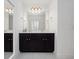 Modern bathroom with double vanity and large mirror at 3241 Wauseon Dr, St Cloud, FL 34772