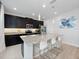Contemporary kitchen featuring dark cabinetry and granite island at 3241 Wauseon Dr, St Cloud, FL 34772