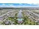 Aerial view of a lakefront community with houses and a central pool area at 3241 Wauseon Dr, St Cloud, FL 34772