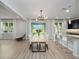 Bright dining room with farmhouse table and modern chandelier at 3241 Wauseon Dr, St Cloud, FL 34772