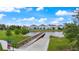 Wooden dock and walkway over calm lake water, houses in background at 3241 Wauseon Dr, St Cloud, FL 34772