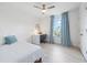 Cozy bedroom with a bed, desk and chair, and a window with blue curtains at 3241 Wauseon Dr, St Cloud, FL 34772