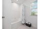 Clean bathroom with a shower/tub combo and floral shower curtain at 3241 Wauseon Dr, St Cloud, FL 34772