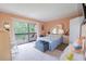 Bedroom with a queen bed, dresser, and sliding glass doors leading to a balcony at 5038 Downing St # 7, Orlando, FL 32839