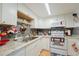 Well-equipped kitchen with white cabinets and granite counters at 5038 Downing St # 7, Orlando, FL 32839