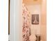 Bathroom with toilet, shower, and decorative artwork at 5038 Downing St # 7, Orlando, FL 32839
