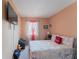 Bedroom with a king-size bed and a large TV at 5038 Downing St # 7, Orlando, FL 32839