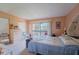 Bright bedroom with a queen bed, dresser, and access to a balcony at 5038 Downing St # 7, Orlando, FL 32839