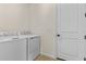 Bright laundry room, features side-by-side washer and dryer at 2303 Jagger Ln, Eagle Lake, FL 33839