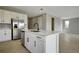 Modern kitchen with white cabinets, quartz countertops, and stainless steel appliances at 155 Bull Frog Ln, Umatilla, FL 32784