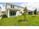 Spacious backyard with grassy area and patio at 155 Bull Frog Ln, Umatilla, FL 32784