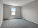 Well-lit bedroom with neutral walls and carpet at 155 Bull Frog Ln, Umatilla, FL 32784