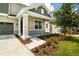 Two-story house with gray siding, stone accents, and a covered porch at 155 Bull Frog Ln, Umatilla, FL 32784