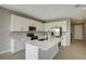 Modern kitchen with white cabinets, quartz countertops, and stainless steel appliances at 155 Bull Frog Ln, Umatilla, FL 32784