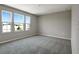Spacious bedroom with three windows and grey carpeting at 155 Bull Frog Ln, Umatilla, FL 32784
