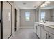 Spacious bathroom with double sinks, a shower, and large windows at 155 Bull Frog Ln, Umatilla, FL 32784