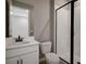 Clean bathroom with white vanity, black hardware, and a frameless shower at 155 Bull Frog Ln, Umatilla, FL 32784