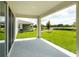 Covered patio with view of grassy backyard at 155 Bull Frog Ln, Umatilla, FL 32784