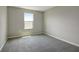 Bright bedroom featuring neutral walls and plush carpeting at 155 Bull Frog Ln, Umatilla, FL 32784
