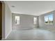 Spacious living room with gray walls, tile floors, and multiple windows at 155 Bull Frog Ln, Umatilla, FL 32784