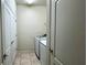 Laundry room with washer, dryer, and extra storage at 2131 Tripoli Ct, Kissimmee, FL 34747